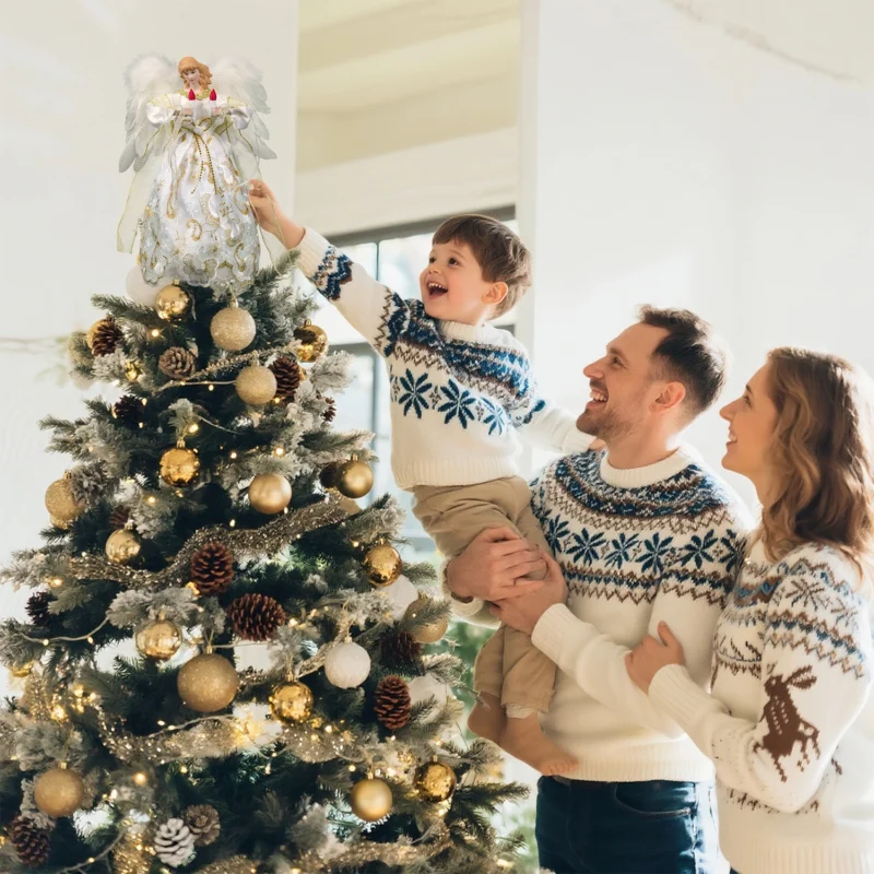 Heartwarming Christmas moment: father helps boy put angel tree topper while mother looks on smiling