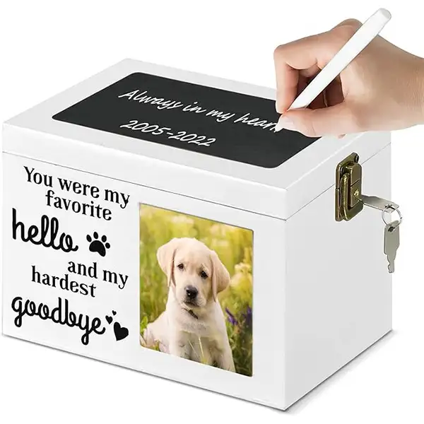 pet-memorial-keepsake-box-with-writable-black-message-plate (1) A hand is writing on the message board of a white pet memorial keepsake box
