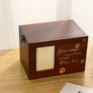 wooden-pet-keepsake-box-with-photo-frame-for-dogs-or-cats (6) A pet keepsake box is on the table.