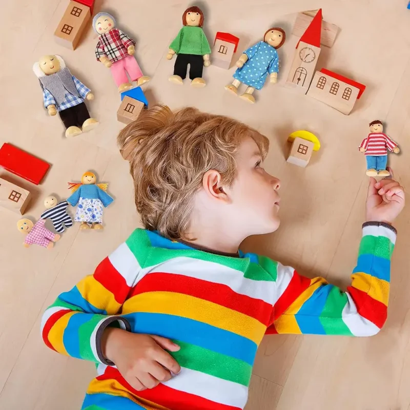 a-boy-is-playing-the-dollhouse-dolls-set A child is playing with the family dollhouse dolls set